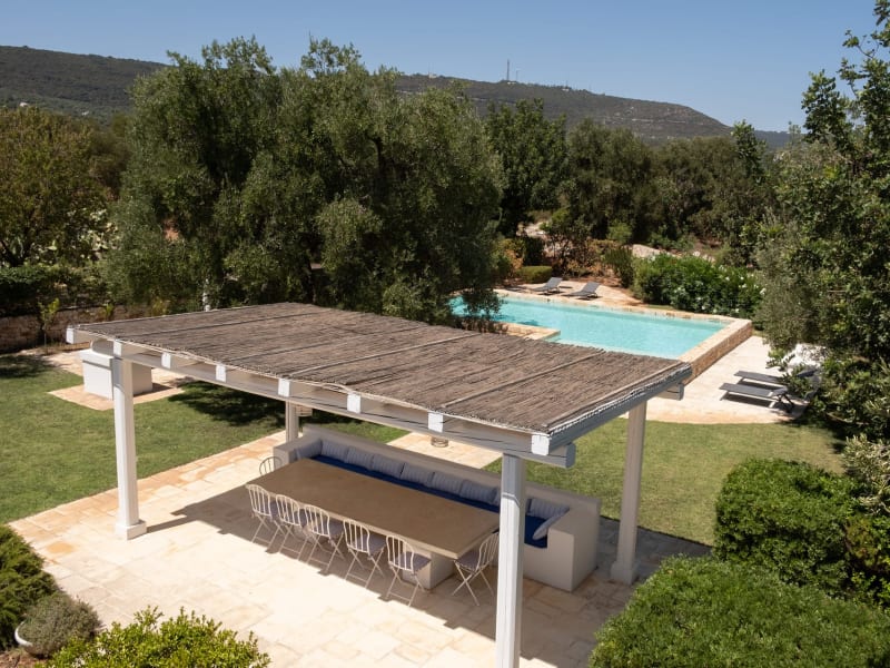 The shady al fresco dining area, the pool and the luxuriant gardens.