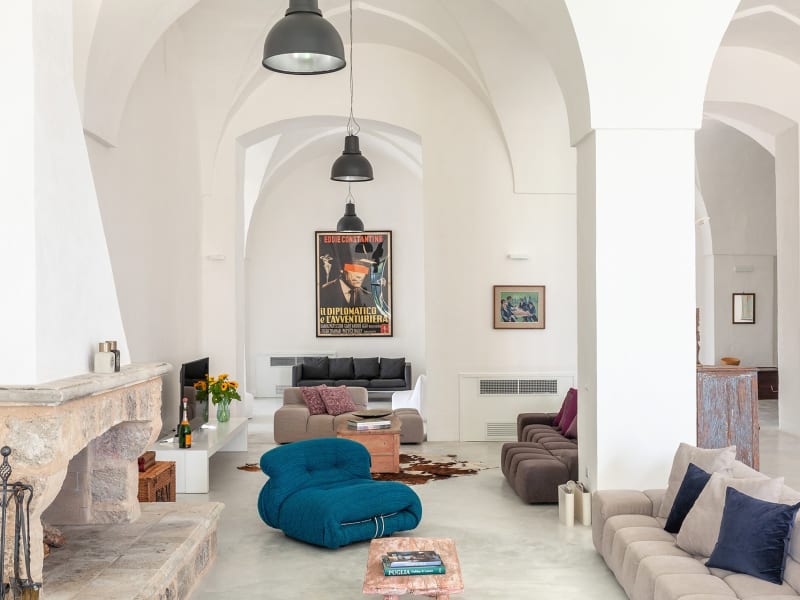 A cosy sitting area around the fireplace in the open-plan communal space.
