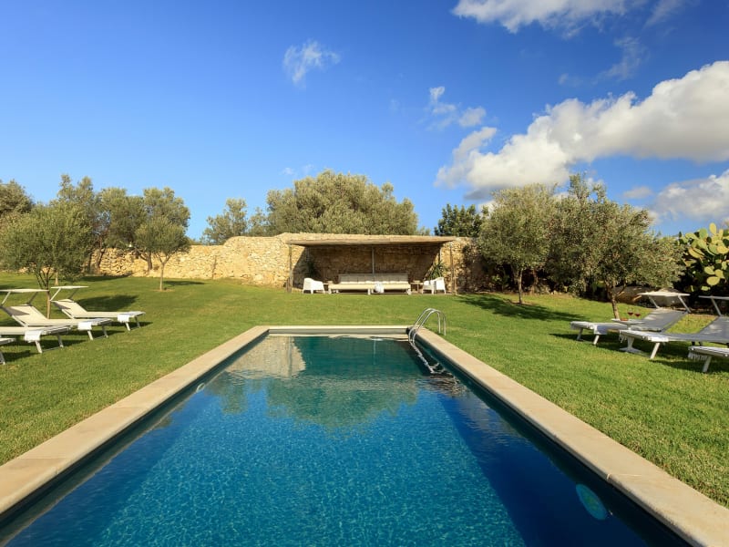 The cobalt blue pool surrounded by emerald green lawns.