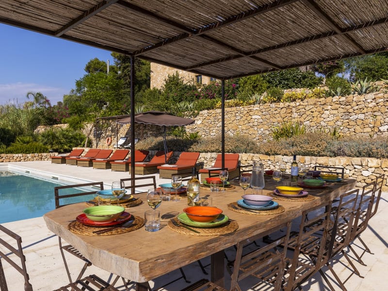 The shady al fresco dining area down by the pool.