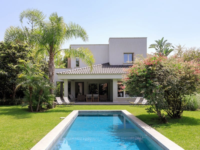 The elegant pool and green gardens.