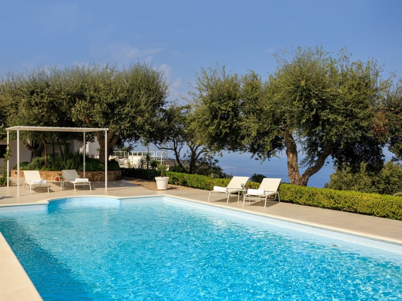 The panoramic, olive tree-flanked pool has mountain and sea views.