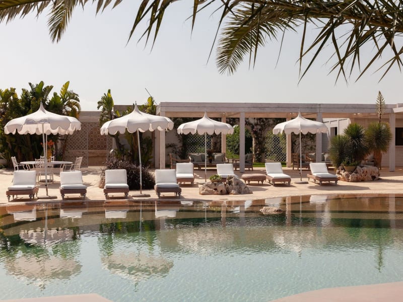 The main pool is served by shady pergolas, well-furnished sitting areas, daybeds, loungers, a bar, showers, a WC and a dining area.