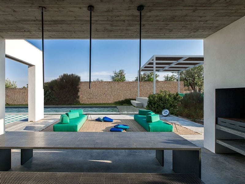 A view of the pool area from the outdoor kitchen and dining area (an architect's rendering).