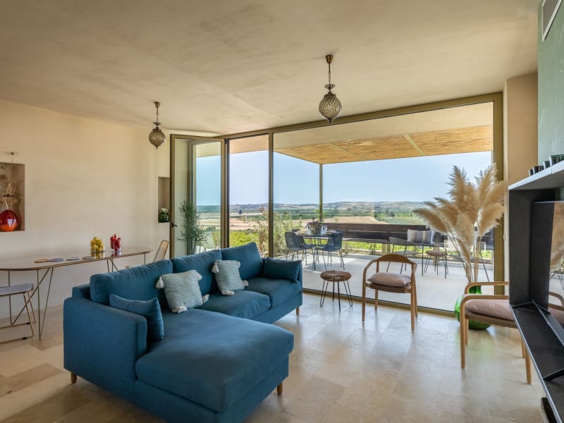 The open-plan communal area with its wall of glass, views and terrace access.