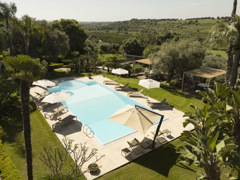 The vivid greens of the manicured gardens and the surrounding countryside.