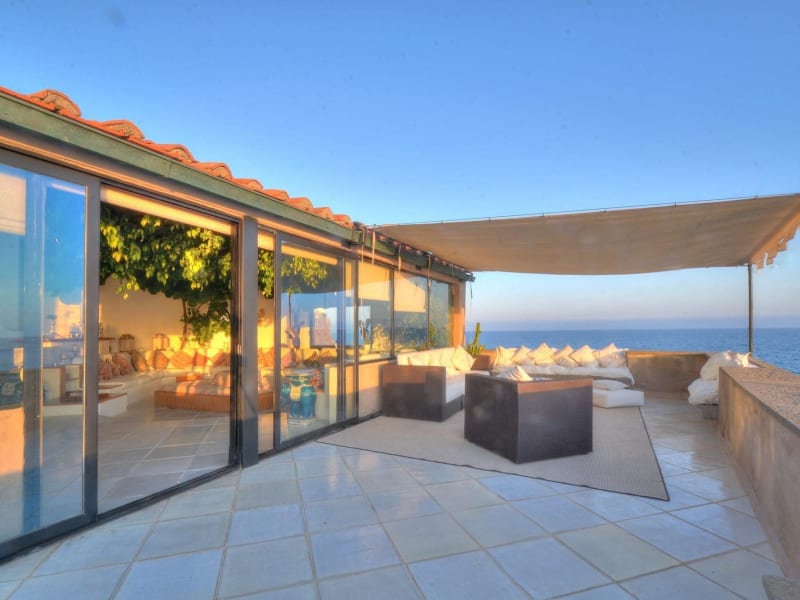 Wide, sliding glass doors allow the main living room to flow outside with the minimum fuss.