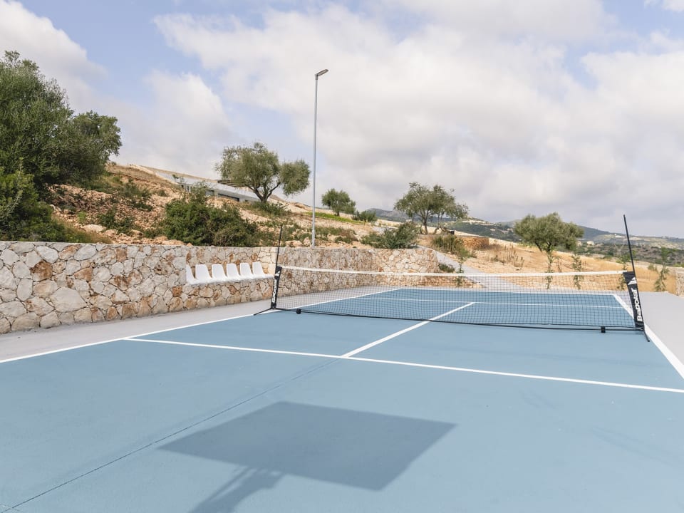 A mini tennis court with basketball hoop is perfect for sports lovers.