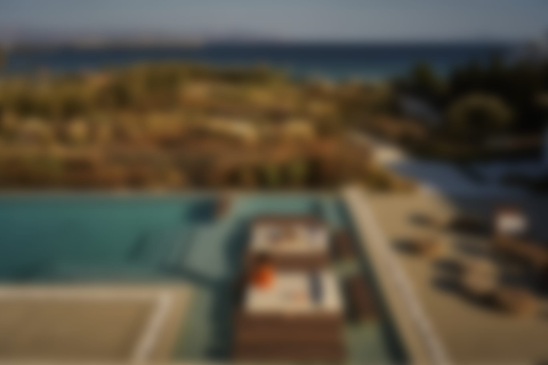 Santhia's "floating" wooden daybeds in the shallow end of the pool, and the views out to sea.