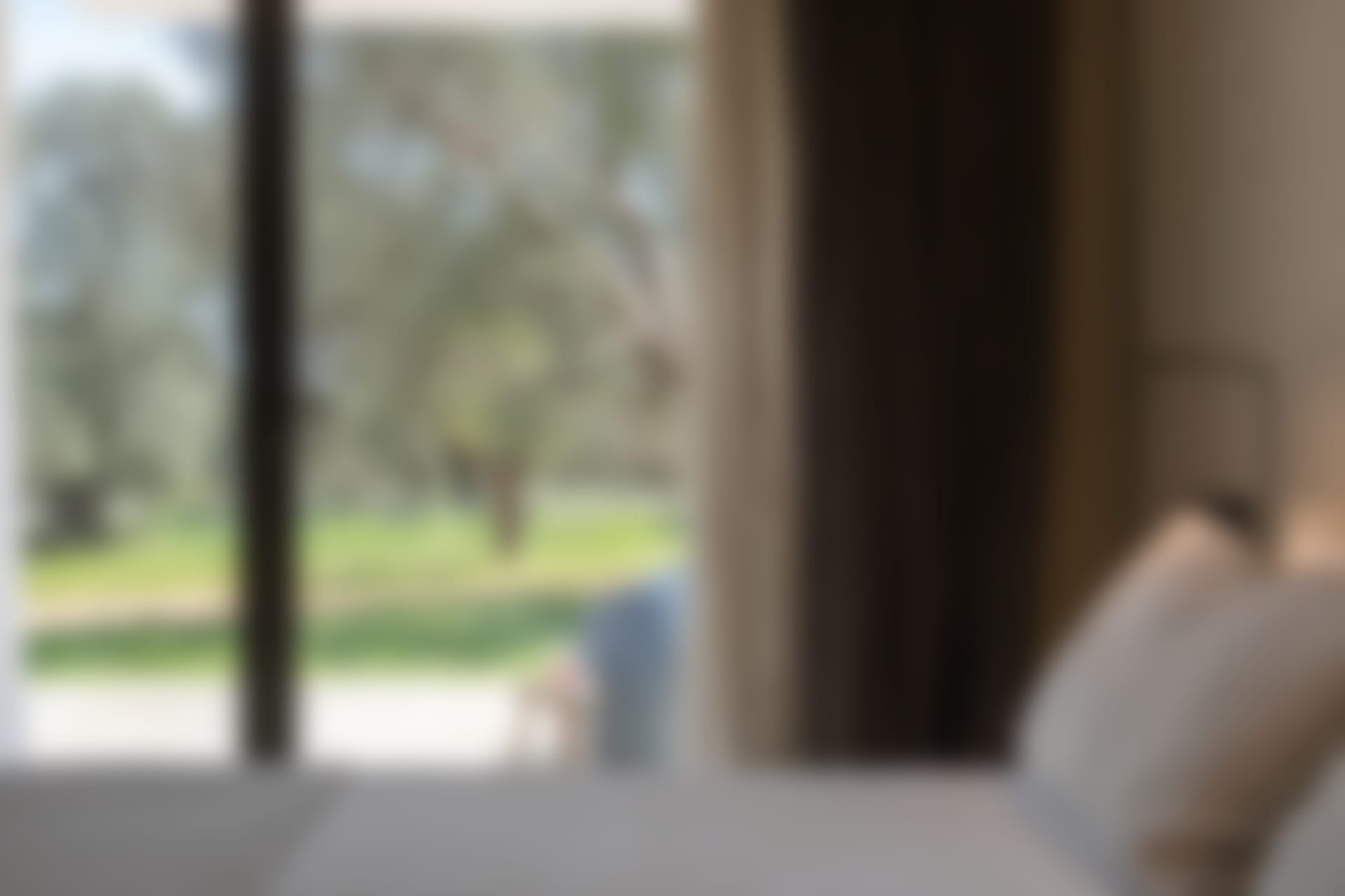 The same bedroom, with its terrace access and garden views.