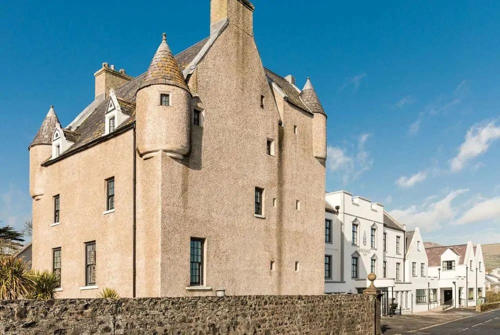 Ballygally Castle in Northern Ireland, a historic haunted hotel with turreted architecture. Photo by Wexas Travel. Ballygally Castle in Northern Ireland, a historic haunted hotel with turreted architecture. Photo by Wexas Travel.