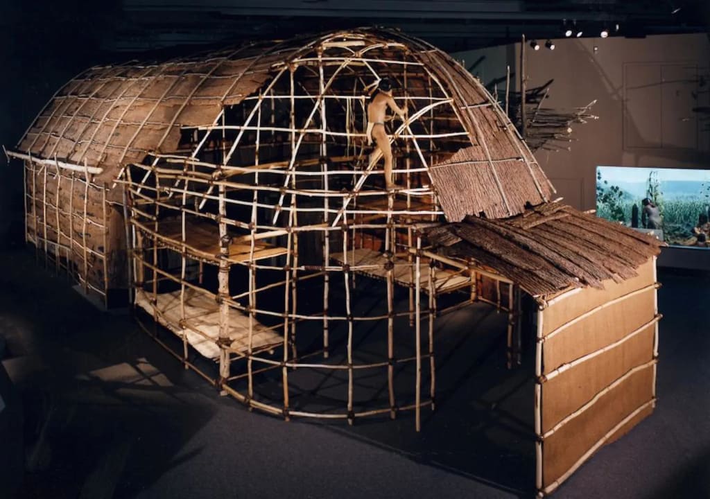 Traditional Haudenosaunee longhouse showing its wooden frame and natural material construction, exemplifying Indigenous architectural traditions and social structure. Public domain. Traditional Haudenosaunee longhouse showing its wooden frame and natural material construction, exemplifying Indigenous architectural traditions and social structure. Public domain.