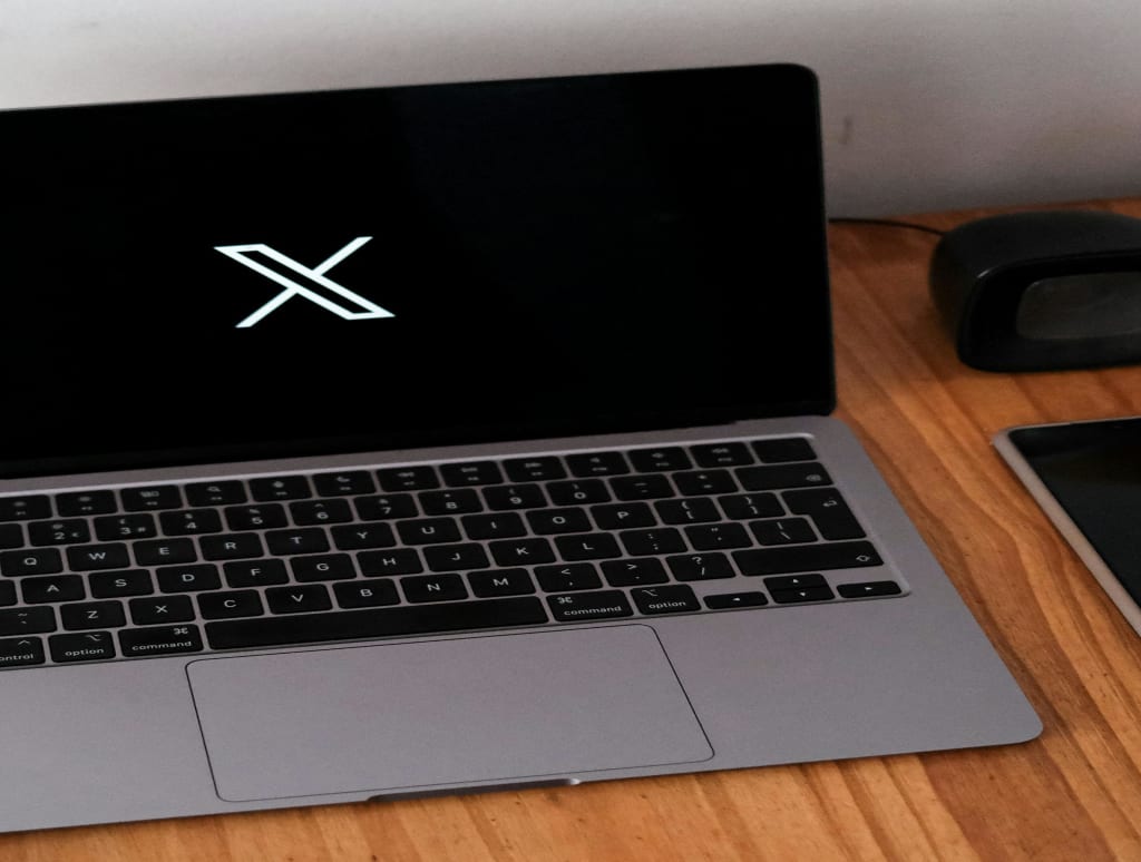 Laptop with X Social Media Icon on Desk. Elon Musk's Trump support drives 700k users from X to Bluesky