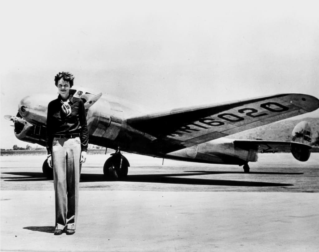 Amelia Earhart standing in front of the Lockheed Electra in which she disappeared in July 1937. Photo by Smithsonian Institution. Amelia Earhart standing in front of the Lockheed Electra in which she disappeared in July 1937. Photo by Smithsonian Institution.