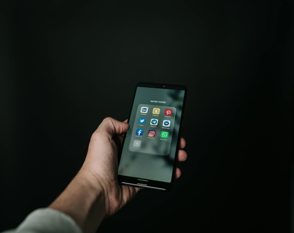 Photo of Hand Holding a Black Smartphone Photo of Hand Holding a Black Smartphone