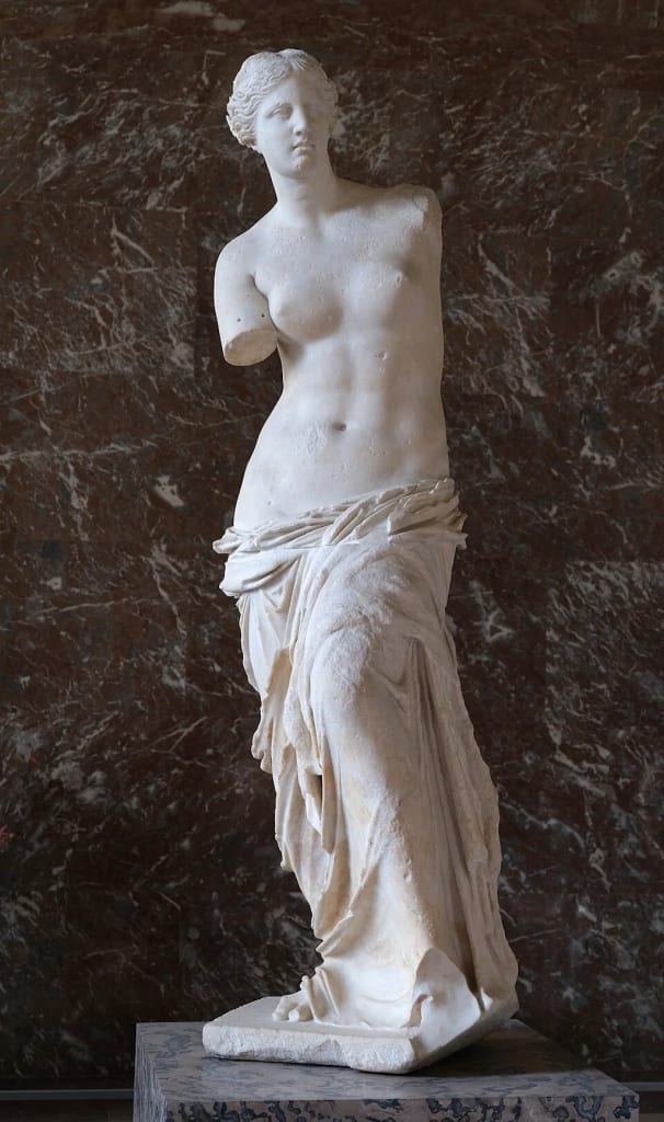 The Venus de Milo, a renowned ancient Greek marble statue, displayed in a grand hall at the Louvre Museum. Public domain. The Venus de Milo, a renowned ancient Greek marble statue, displayed in a grand hall at the Louvre Museum. Public domain.