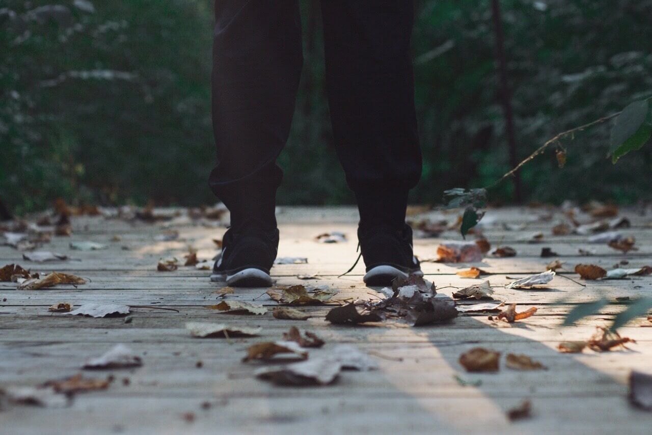 man standing on bridge