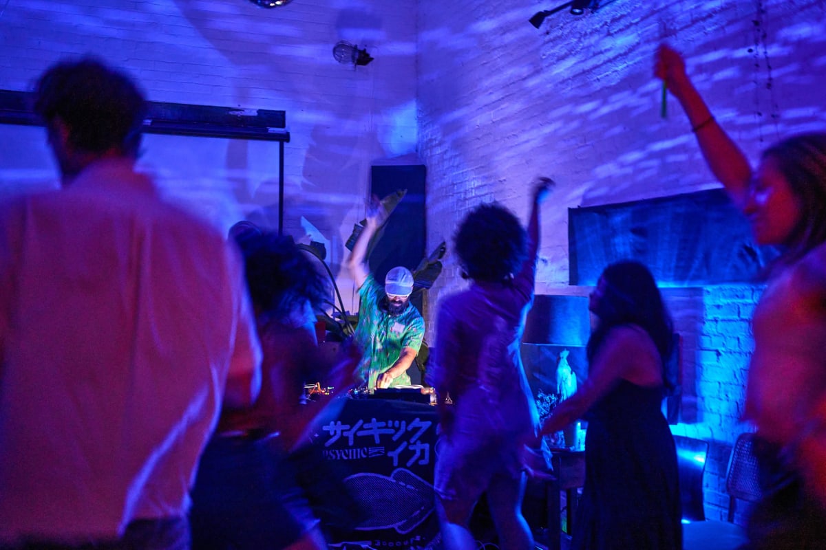 A DJ playing to a full room at a Lighthouse party