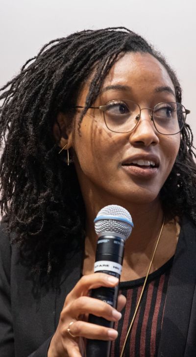 Tanay Tatum-Edwards at speaking at an event.