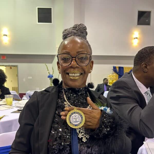 Ms. Ruby Welch Smiling Showing NAACP Award at Event