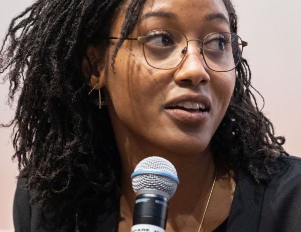 Tanay Tatum-Edwards at speaking at an event.