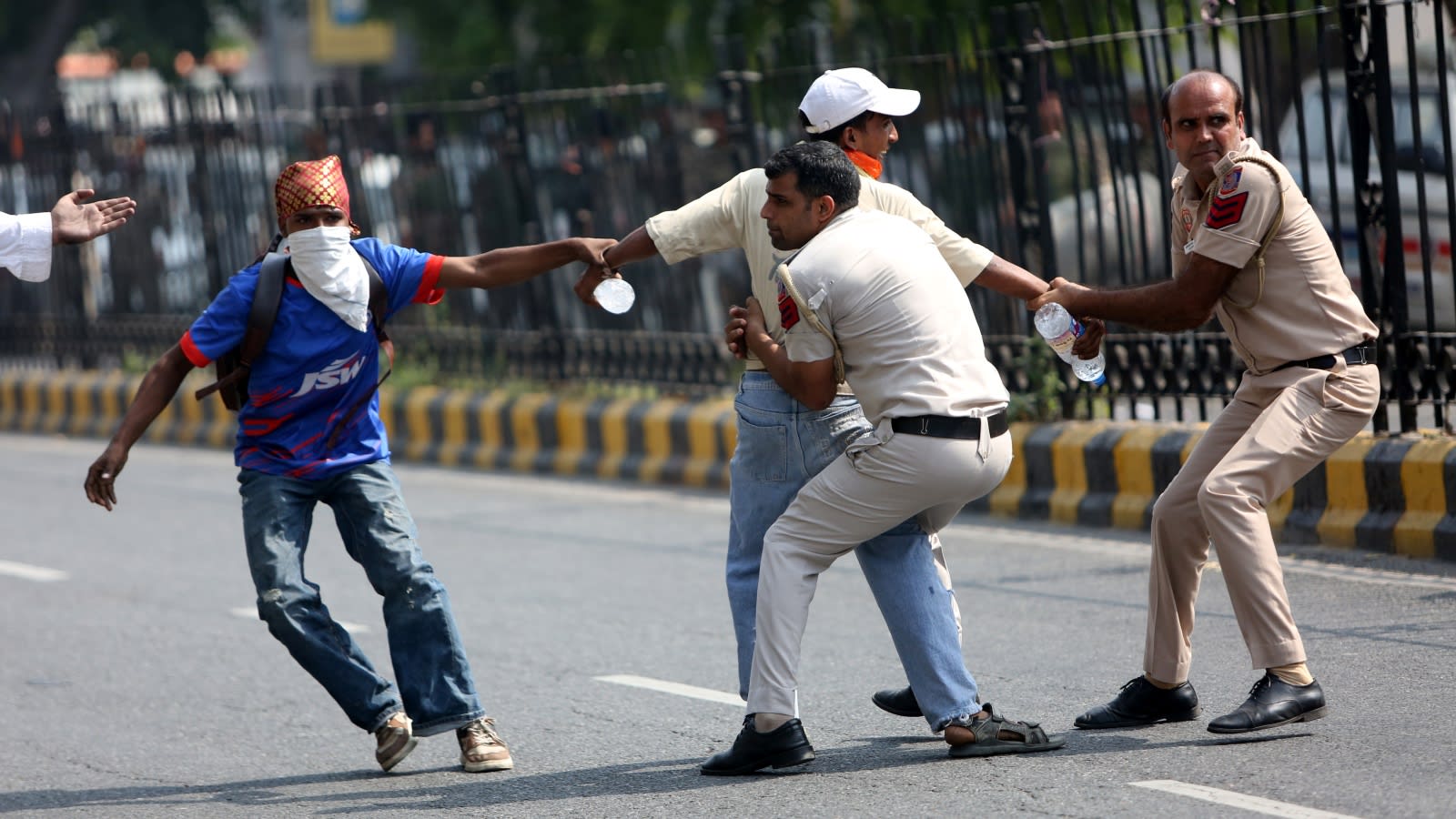 Amid stir against election chief, protester thrashed, stones thrown at bus of detainees