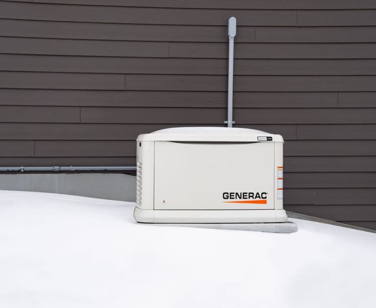  Generac generator outside in the snow outside a home