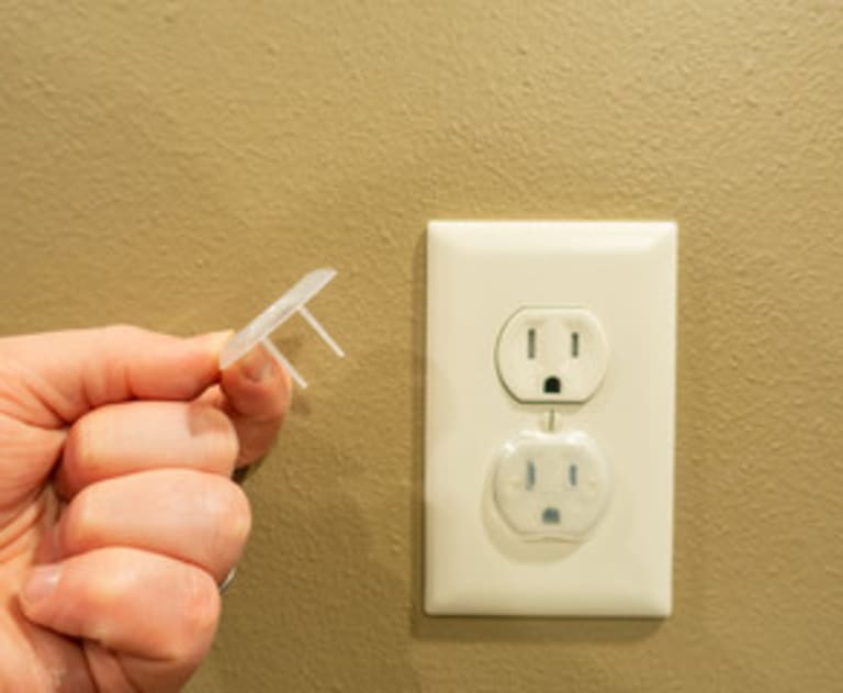 Childproofed outlet cover
