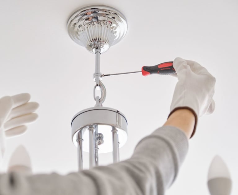 Electrician removing a discontinued lighting type