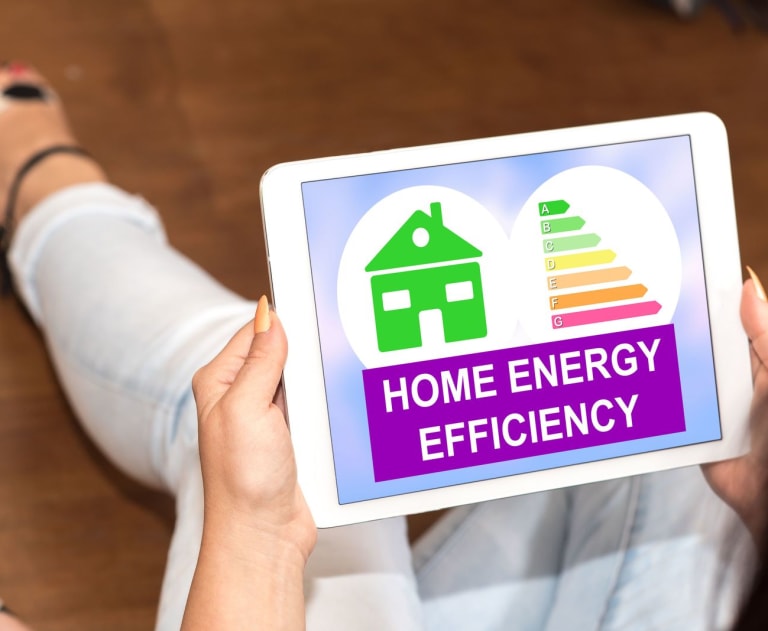 Woman holding guide to home energy efficiency