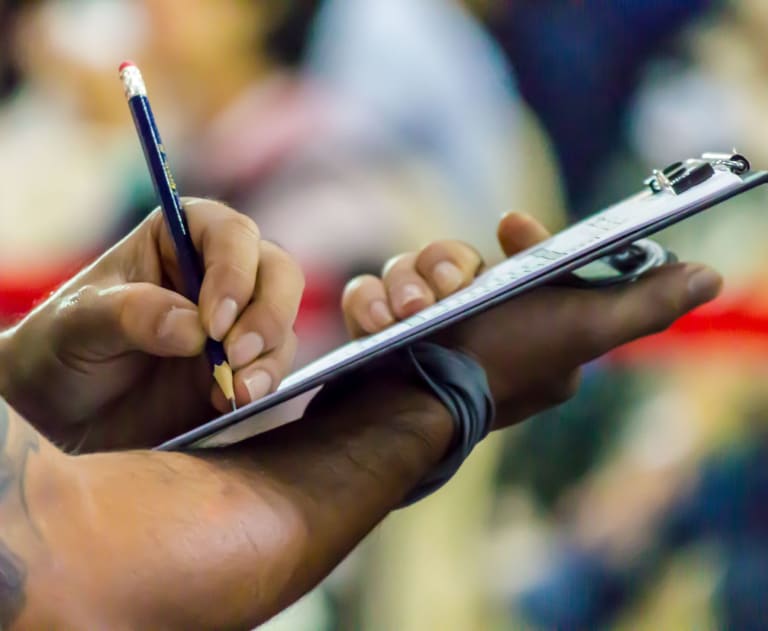 Person with an electrical fire safety checklist on a clipboard
