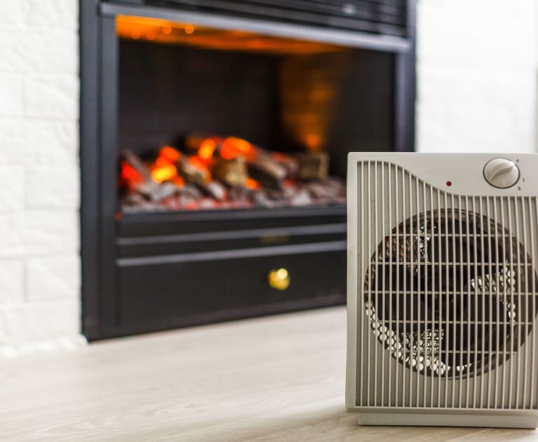 Space heater in front of a fire place