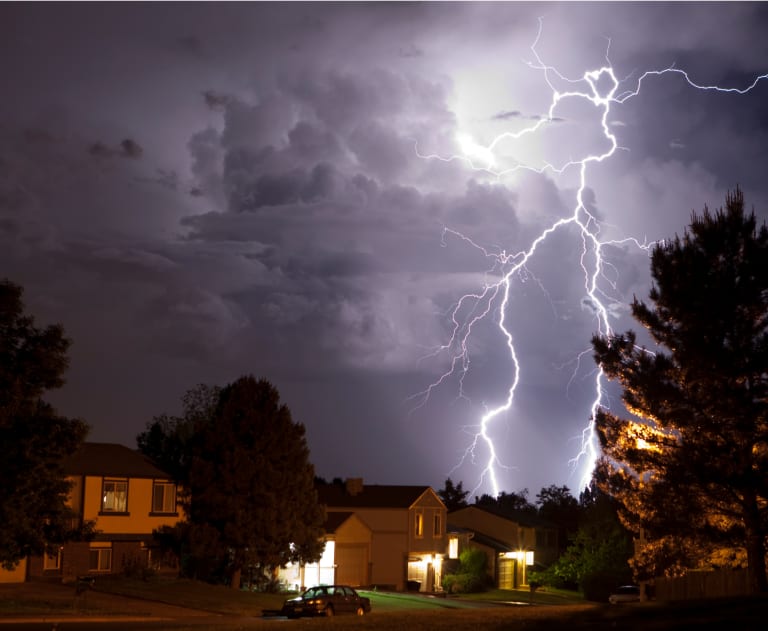 Large lightning strike over house with whole house surge protector
