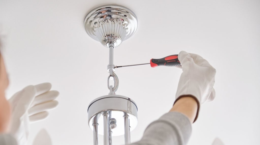 Electrician removing a discontinued lighting type