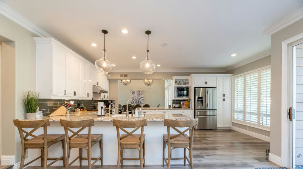 Brightly lit kitchen with many light fixtures