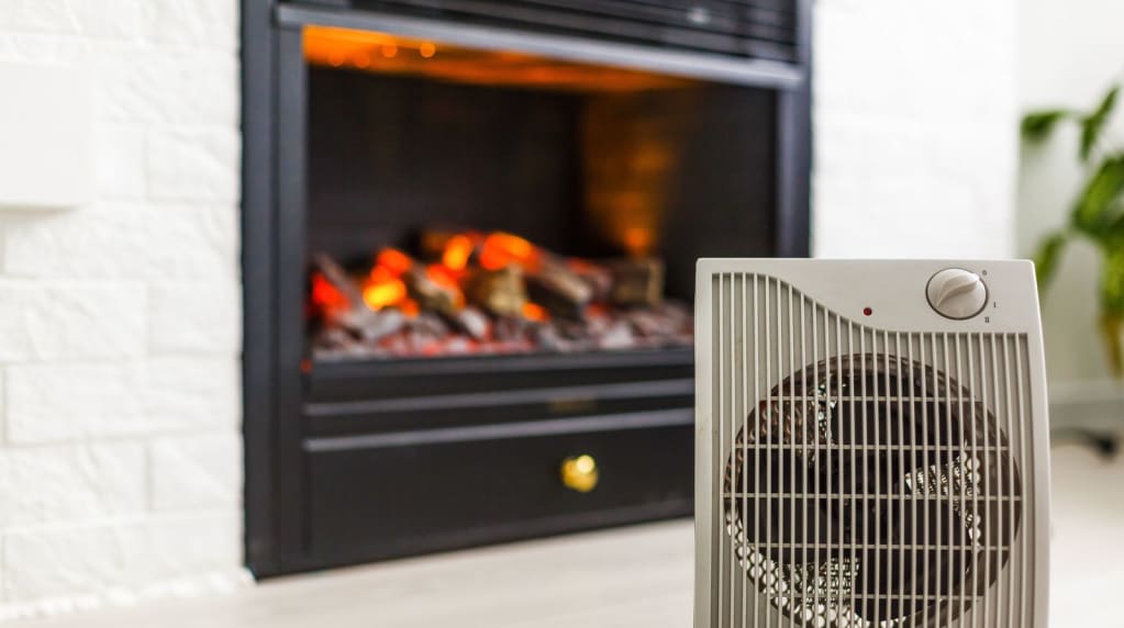 Space heater in front of a fire place