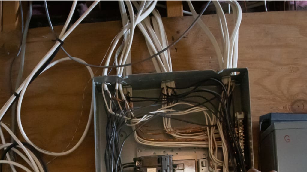Electrician testing circuit breaker box