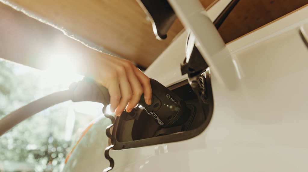 Person plugging in an EV charger