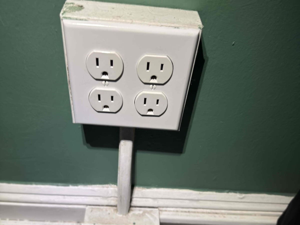 four outlets on a green wall