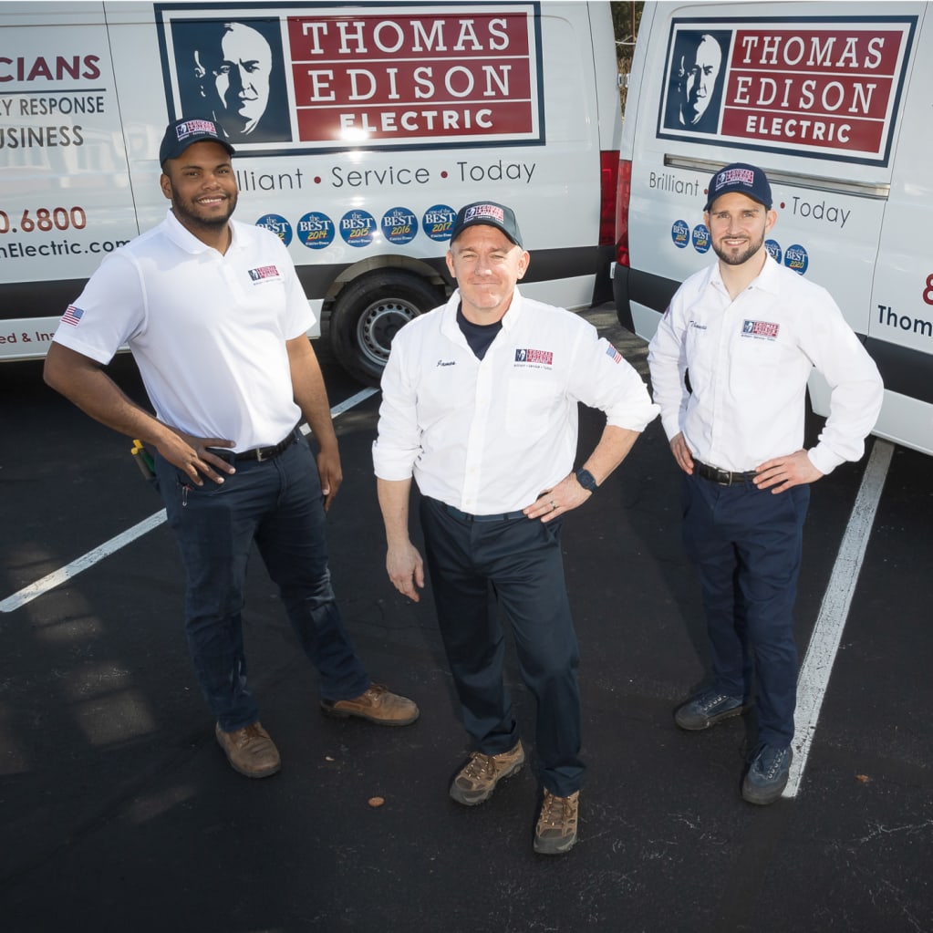 Electricians standing by trucks