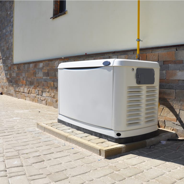 Newly installed backup generator outside of a building