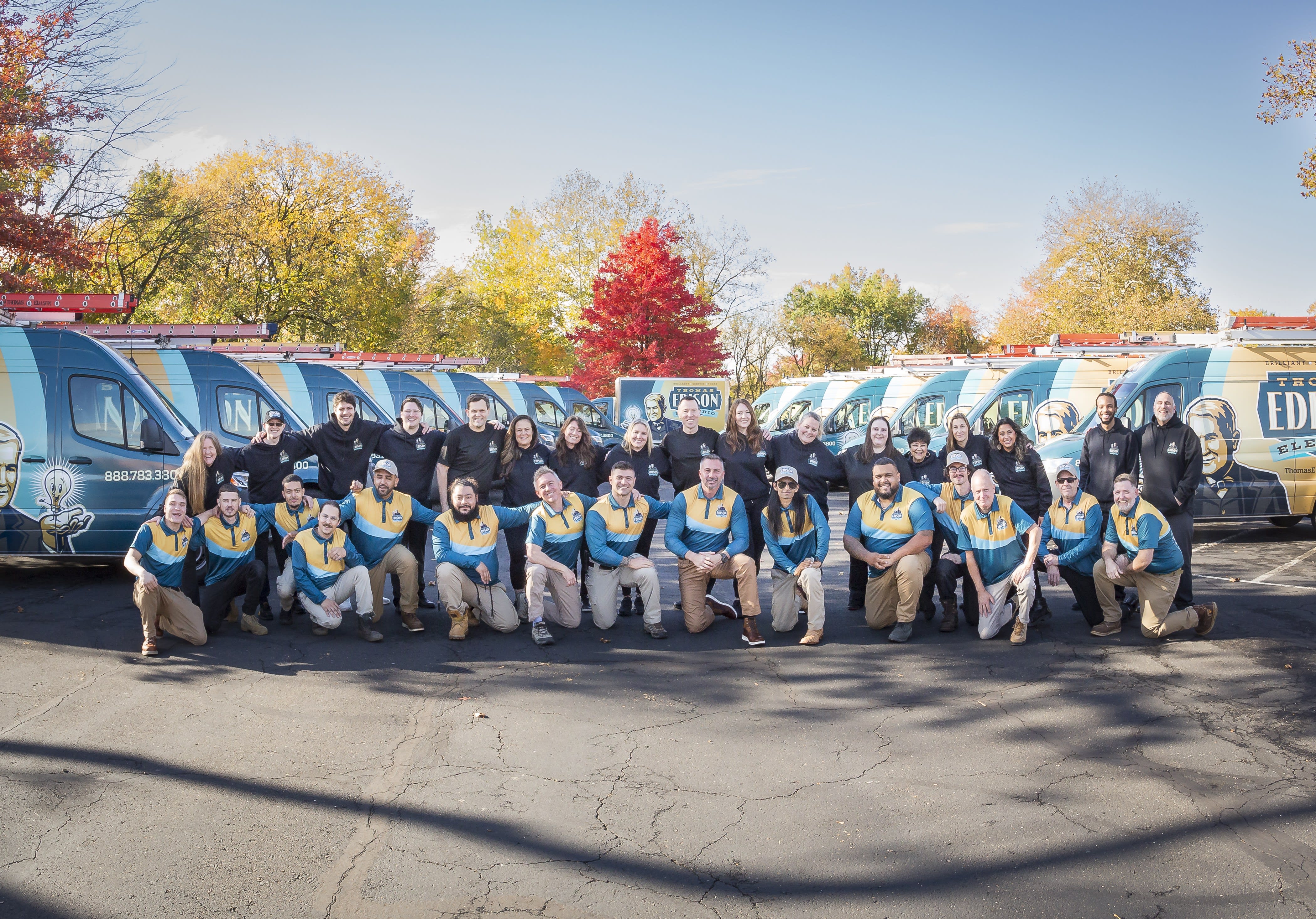 The full Thomas Edison Electric team in front of the company van fleet