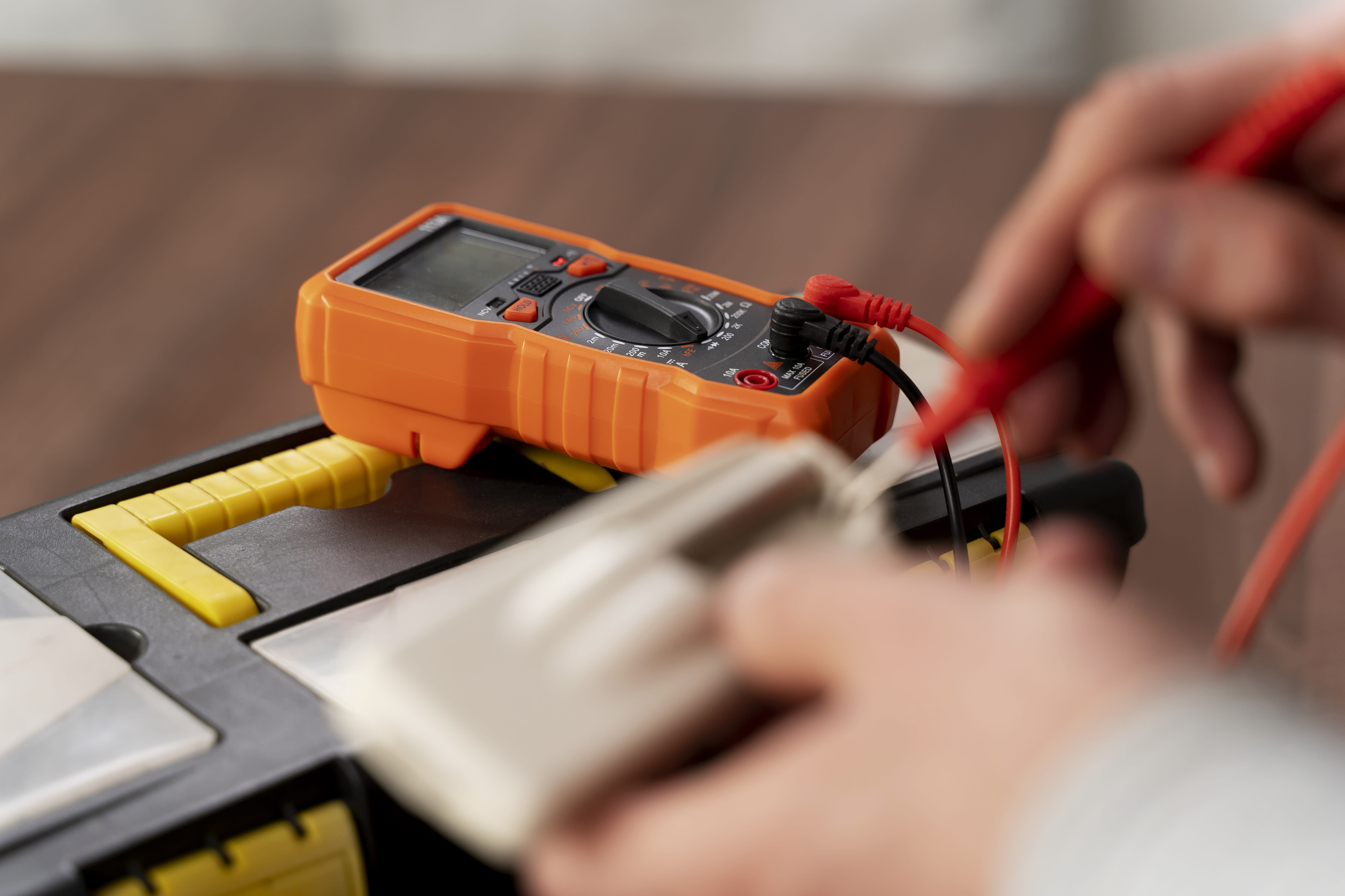 Electrician using a multimeter