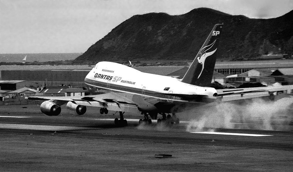Black and white photo of an old jumbo jet touching down