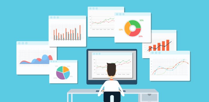 man sitting in front of the computer surrounded by graphs