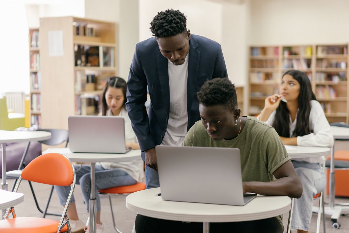 Students working on laptops in a classroom