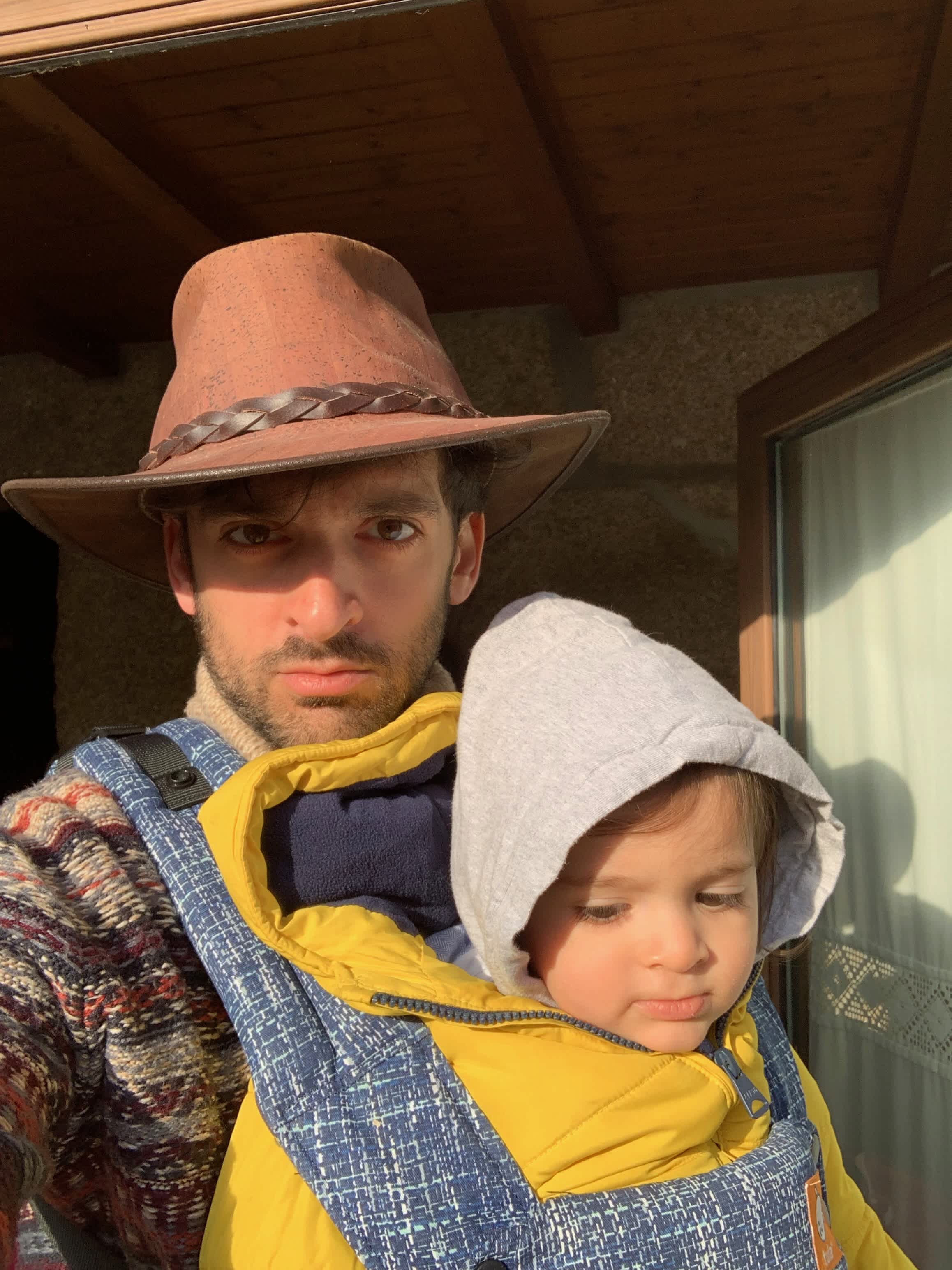 Diogo with son and wearing a hat