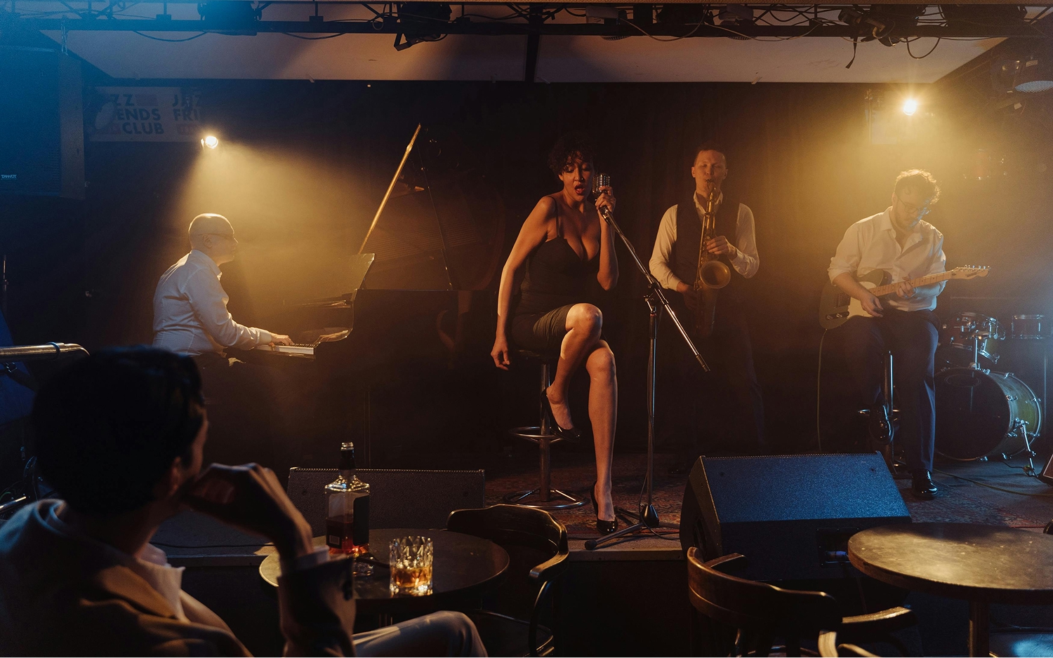 Jazz performers on a stage in a dark venue