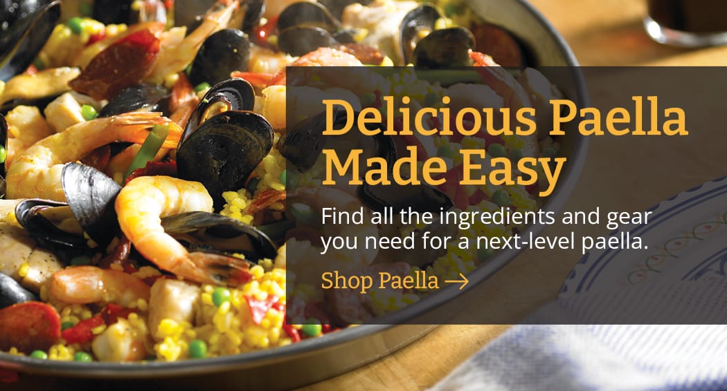 Sliced Jamon in a plate with some olives and a knife out of focus