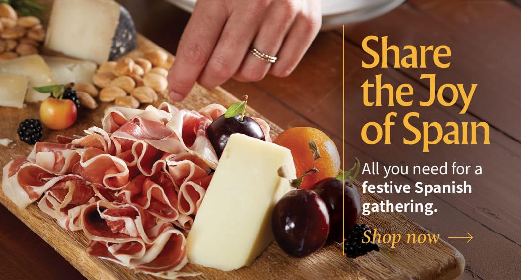 Sliced Jamon in a plate with some olives and a knife out of focus
